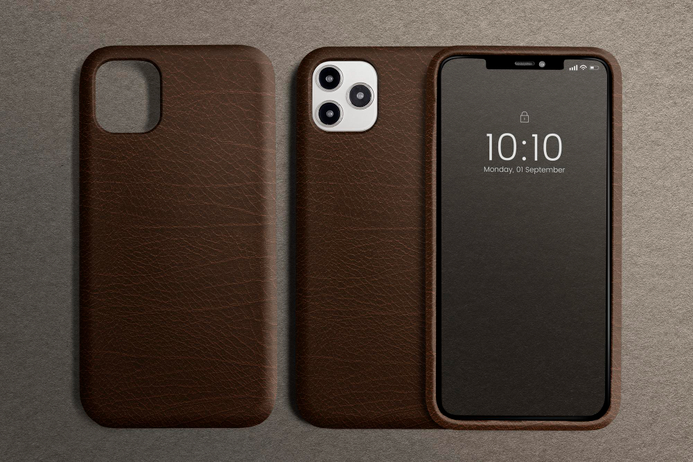 Brown leather rugged iPhone case shown from front and back with camera cutout and protective frame on a neutral background.