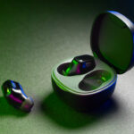 Wireless noise-cancelling earbuds with charging case on dark background featuring modern compact in-ear design