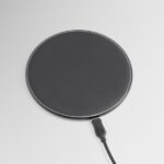 MagSafe car mount with a round magnetic charging pad and attached cable.