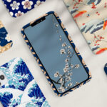 iPhone 17 with slim decorative case surrounded by Japanese-style patterned phone cases